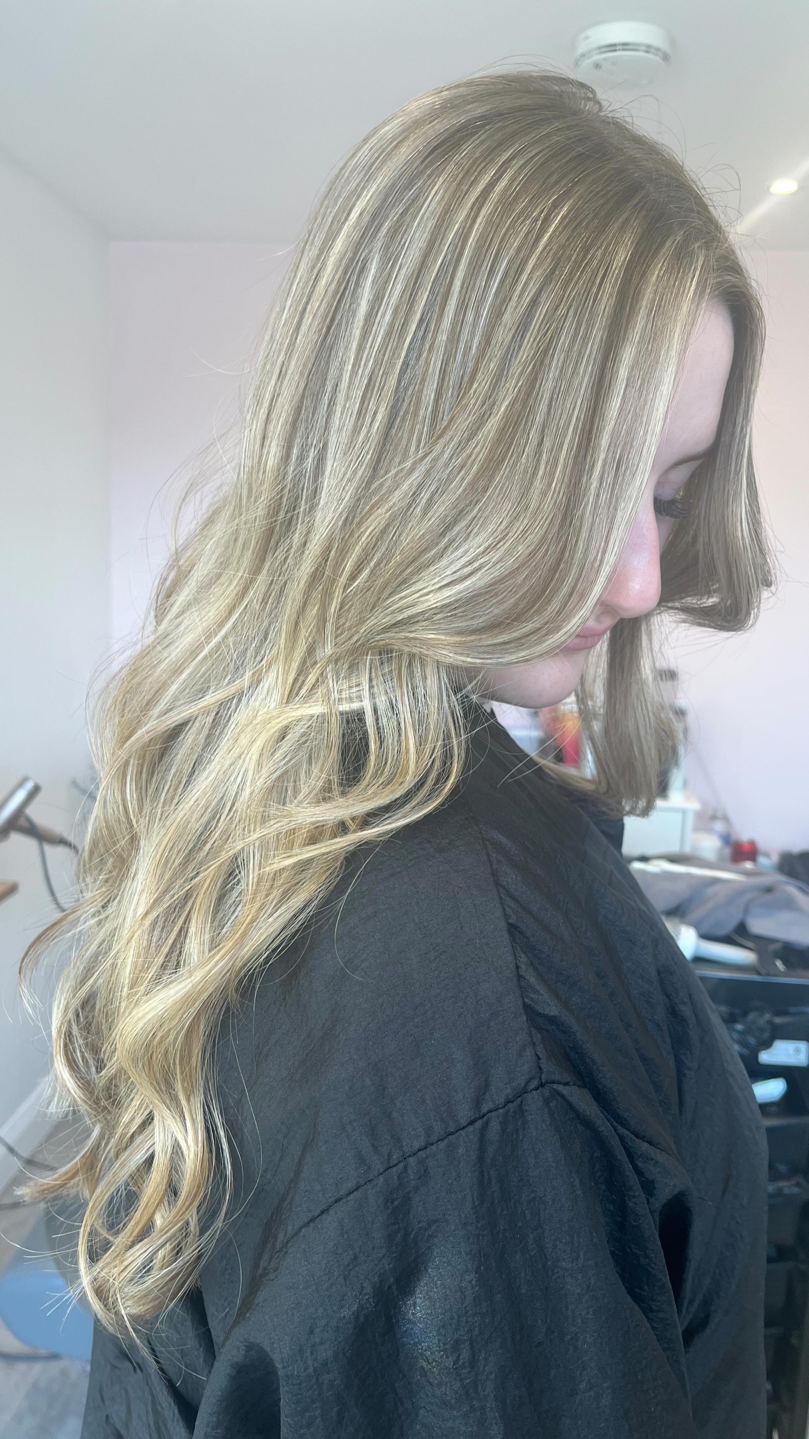 Long sunlit blonde hair with blended, natural-looking highlights